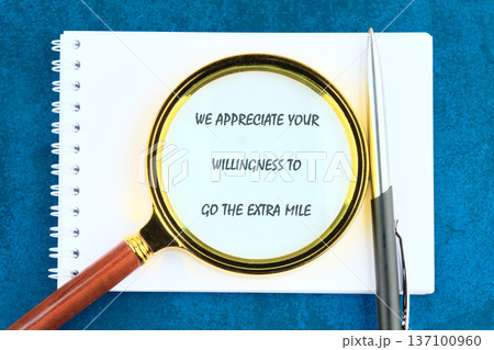 Blue surface: spiral notebook, magnifying glass on hard work message, sleek pen. Celebrates excel drive Blue surface: spiral notebook, magnifying glass on hard work message, sleek pen. Celebrates excel drive 137100960