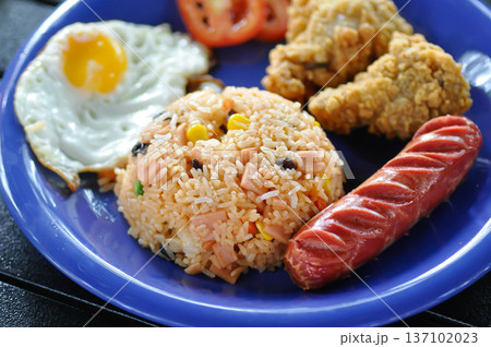 stir fried rice or fried rice with sunny side up egg , fried chicken and sausage 137102023
