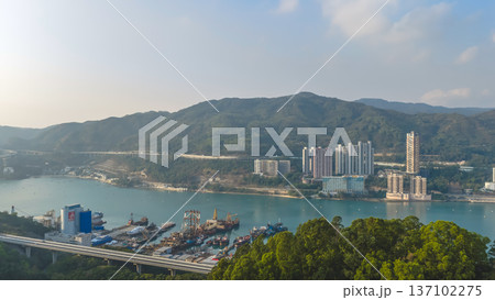 Scenic Hillside Coastline Blending Industry, Housing, And Natural Landscape Feb 21 2026 137102275