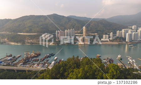 Scenic Hillside Coastline Blending Industry, Housing, And Natural Landscape Feb 21 2026 137102286