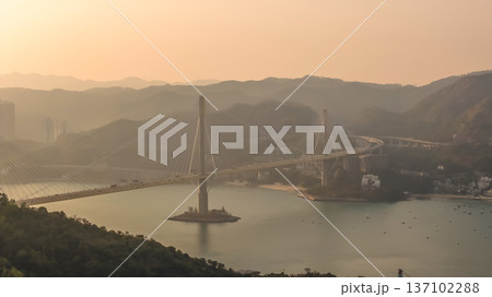 Cable Stayed Bridge Glowing Under Sunset Across Calm Waters Feb 21 2026 137102288