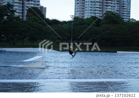 Wakeboarding Adventure Urban Landscape Lake Setting Wakeboarding Adventure Urban Landscape Lake Setting 137102622