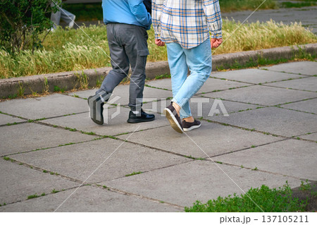 Two young men go about their business in casual clothes Two young men go about their business in casual clothes 137105211