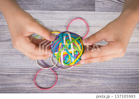 Preschooler hands with ball of rubber bands or erasers Preschooler hands with ball of rubber bands or erasers 137105993