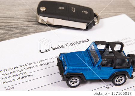 Car sale contract, blue toy car and black key. Sales, purchases of vehicle 137106017