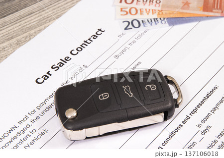 Form of car sale agreement, car key and euro banknotes. Sales, purchases new or used vehicle 137106018