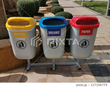 Three colored recycling bins for plastic organic and paper waste collection for environmental signage and recycling awareness poster 137106774