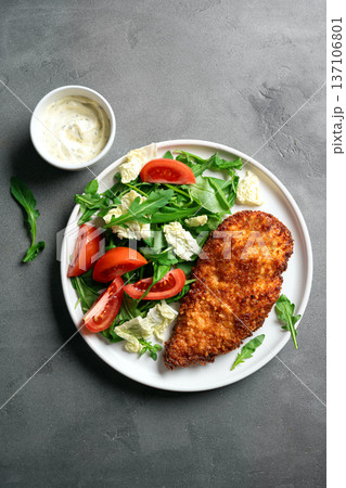 Breaded Chicken with vegetable salad 137106801
