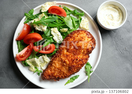 Breaded Chicken with vegetable salad 137106802