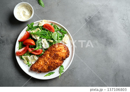 Breaded Chicken with vegetable salad 137106803