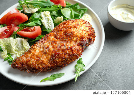 Breaded Chicken with vegetable salad 137106804