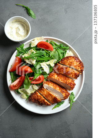 Breaded Chicken with vegetable salad 137106805