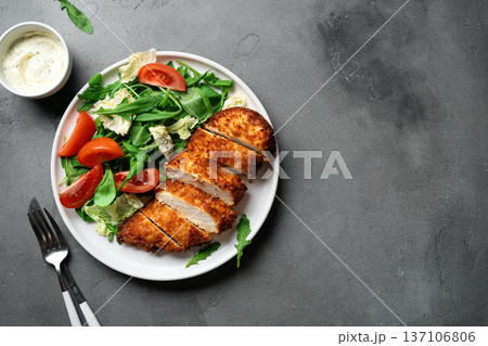 Breaded Chicken with vegetable salad 137106806