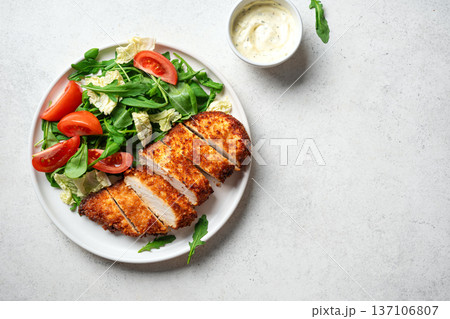 Breaded Chicken with vegetable salad 137106807