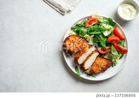 Breaded Chicken with vegetable salad 137106808