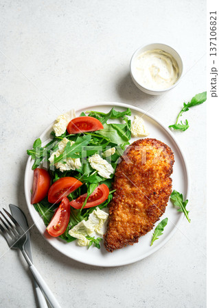 Breaded Chicken with vegetable salad 137106821