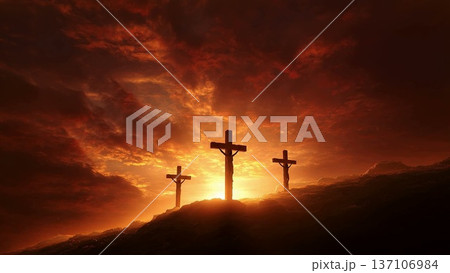 Three crosses on a hill silhouetted against a time-lapse sunrise. The crucifixion of Jesus Christ representing faith, hope, and resurrection. Christian Easter and Good Friday concept 137106984