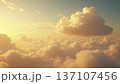 Wide Shot of Fluffy Cloud at Sunrise with Warm Golden Light and Copy Space 137107456