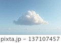 Wide Shot of Single Fluffy White Cloud Floating Against Light Blue Sky with Copy Space 137107457