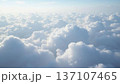 Aerial Wide Shot of Fluffy White Cloud Stretching Endlessly Below Pale Blue Sky with Copy Space 137107465