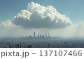 Aerial Wide Shot of Cityscape Under Massive Cumulus Cloud in Daylight with Copy Space 137107466