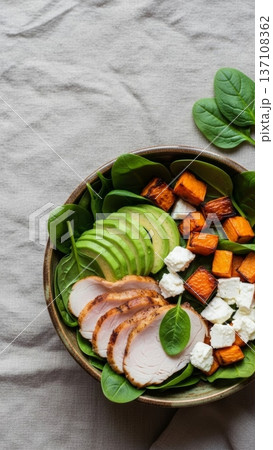 Sliced chicken avocado salad bowl with spinach cubes of roasted sweet potato and feta for healthy menu background and food blog banner Sliced chicken avocado salad bowl with spinach cubes of roasted sweet potato and feta for healthy menu background and food blog banner 137108362
