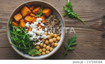 Quinoa and chickpea bowl with roasted squash arugula and feta for healthy lunch bowl and meal prep background 137108366