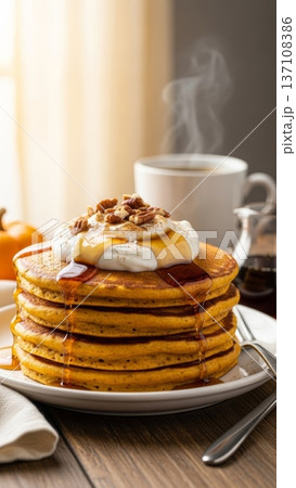 Tall stack of warm pancakes with melting whipped cream syrup and pecans beside steaming coffee cup for cozy breakfast banner Tall stack of warm pancakes with melting whipped cream syrup and pecans beside steaming coffee cup for cozy breakfast banner 137108386