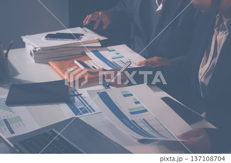 Professional photo of a person's hands reviewing a contract or legal document on a desk, for concepts of business, finance, and legal affairs Professional photo of a person's hands reviewing a contract or legal document on a desk, for concepts of business, finance, and legal affairs 137108704