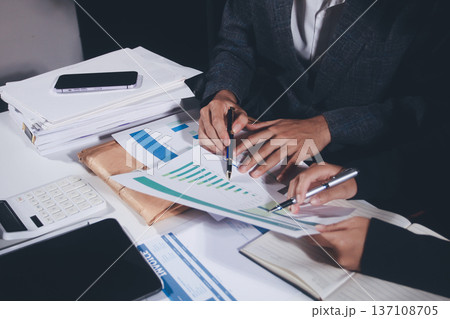 Professional photo of a person's hands reviewing a contract or legal document on a desk, for concepts of business, finance, and legal affairs Professional photo of a person's hands reviewing a contract or legal document on a desk, for concepts of business, finance, and legal affairs 137108705