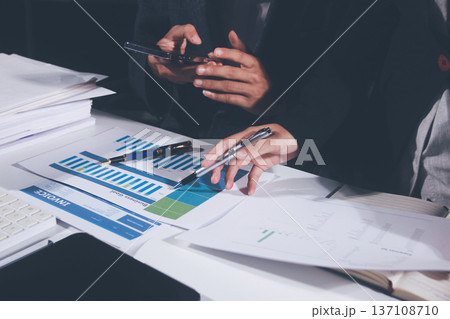 Professional photo of a person's hands reviewing a contract or legal document on a desk, for concepts of business, finance, and legal affairs Professional photo of a person's hands reviewing a contract or legal document on a desk, for concepts of business, finance, and legal affairs 137108710