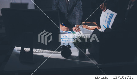 Professional photo of a person's hands reviewing a contract or legal document on a desk, for concepts of business, finance, and legal affairs Professional photo of a person's hands reviewing a contract or legal document on a desk, for concepts of business, finance, and legal affairs 137108716