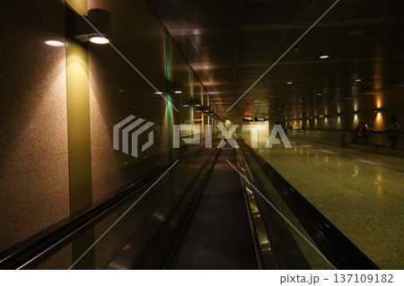 Modern Airport Travelator with Warm Ambient Lighting and Green Accents 137109182