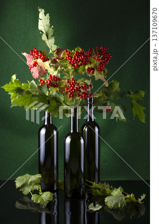 till life with red viburnum branches and glass bottles till life with red viburnum branches and glass bottles 137109670