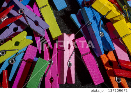A background of many colorful wooden clothespins. A background of many colorful wooden clothespins. 137109671