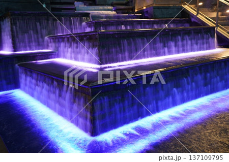 Vibrant Purple and Blue Illuminated Cascading Water Feature 137109795