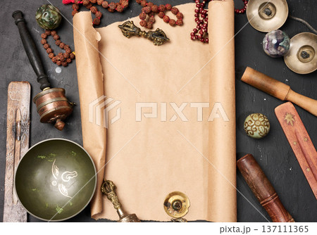 Religious objects for prayer and meditation, with a sheet of brown paper in the middle for writing. Religious objects for prayer and meditation, with a sheet of brown paper in the middle for writing. 137111365