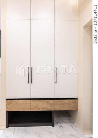 Built in white wardrobe with wood accent base Built in white wardrobe with wood accent base 137114411