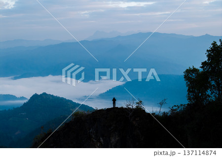 Breathtaking aerial view of mountain ranges and sea of mist at beautiful sunrise. Breathtaking aerial view of mountain ranges and sea of mist at beautiful sunrise. 137114874