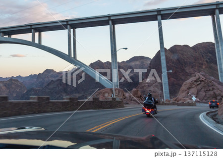 Equipped motorcyclists traveling on winding Equipped motorcyclists traveling on winding 137115128