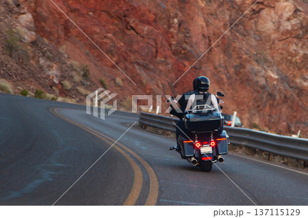 Equipped bikers travel on chopper-style motorcycle 137115129