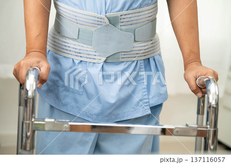 Asian woman injury from falling down on slippery surfaces with walker at home. Asian woman injury from falling down on slippery surfaces with walker at home. 137116057