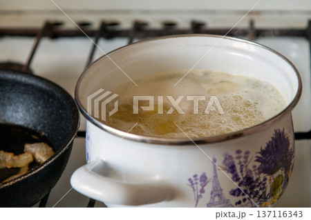 Cooking potatoes and bacon on a gas stove Cooking potatoes and bacon on a gas stove 137116343