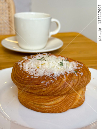 Gourmet pastry with grated cheese and herbs on a plate. Culinary presentation and fine dining. 137117605