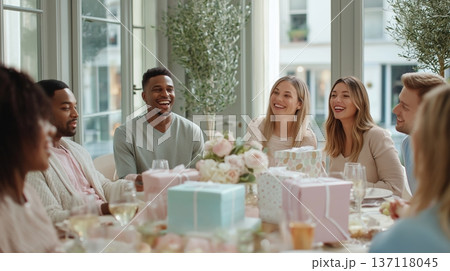 Friends gather for a cheerful celebration during a party with gifts and laughter in a bright room 137118045