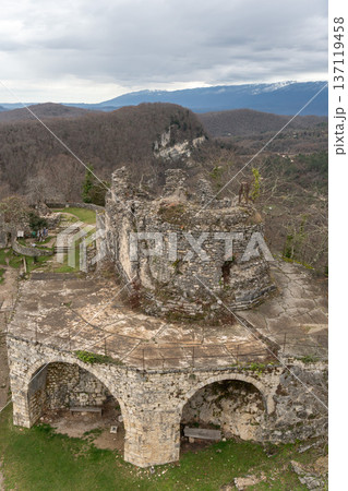Ancient Anacopia fortress ruins with stone walls and arches overlooking mountain landscape in Abkhazia, Historic architecture and archaeological site suitable for tourism promotion, heritage marketing 137119458