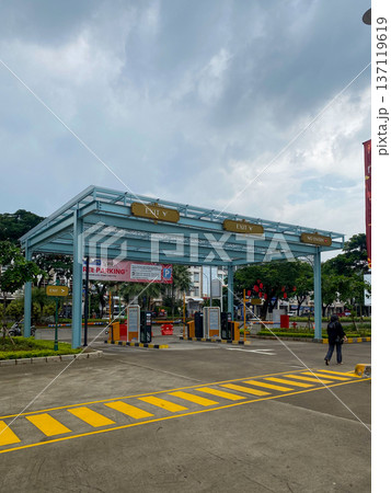 Jakarta, Indonesia - February 08, 2026: Automatic exit gate with parking barrier in Grand Lucky Green Lake City area equipped with free parking information board. 137119619