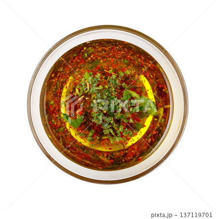Chimichurri sauce with herbs and chili flakes in glass bowl 137119701