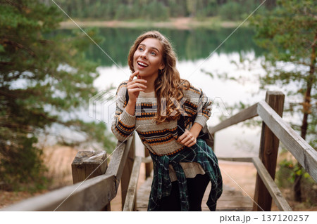 Attractive young woman enjoying fresh air on the lake. Travel, Hiking, nature Attractive young woman enjoying fresh air on the lake. Travel, Hiking, nature 137120257