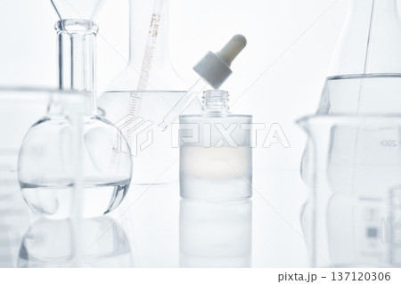 Skincare serum bottle and laboratory glassware in research Skincare serum bottle and laboratory glassware in research 137120306